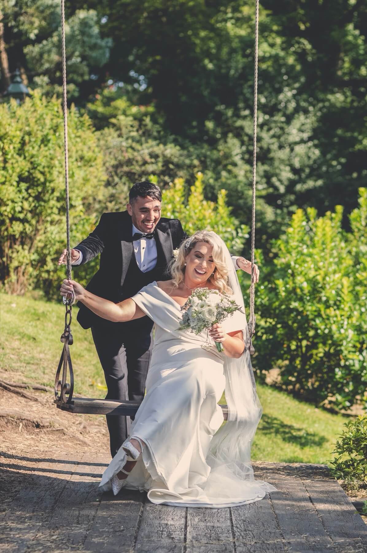 Wedding couple on garden swing Galgorm Resort