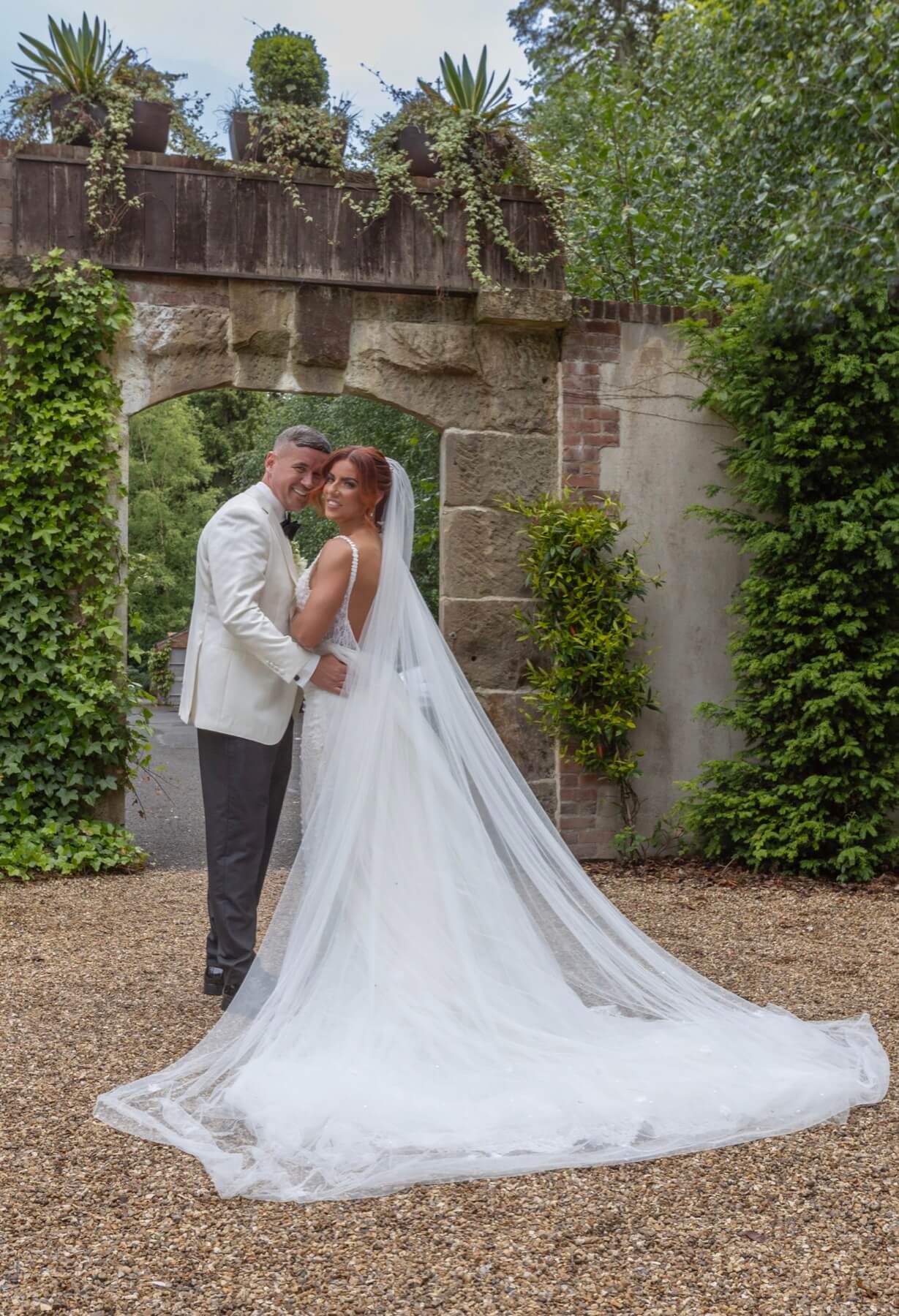 Wedding couple at stone ruins archway Galgorm Resort Northern Ireland wedding photography