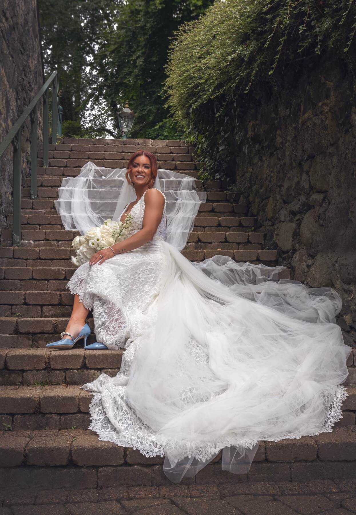 Bride on stone steps Galgorm Resort