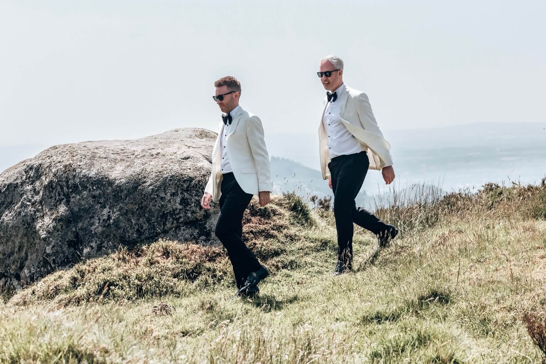 Two grooms walking on Slieve Gullion Killeavy Castle Estate Northern Ireland wedding photography