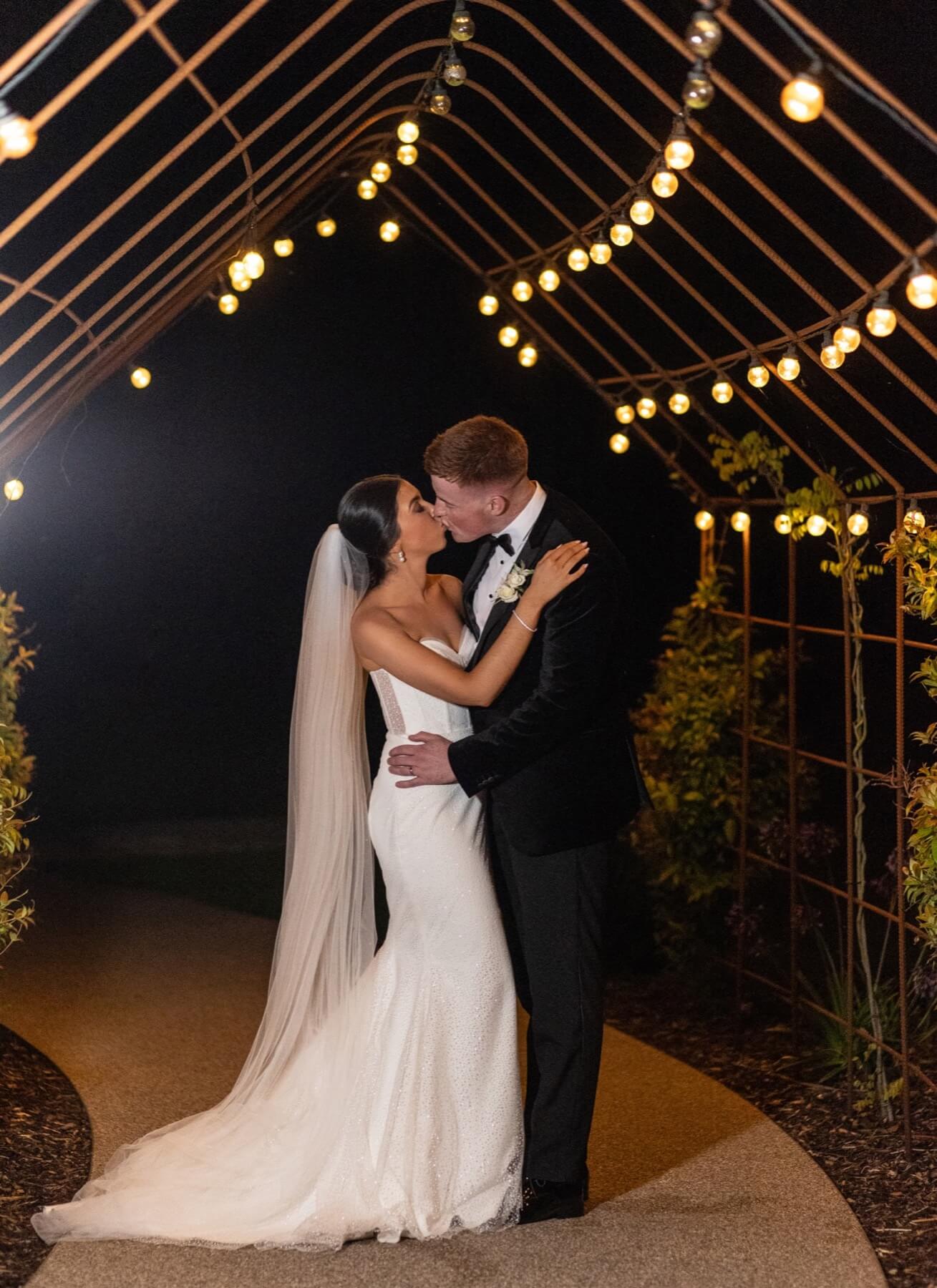 Wedding couple under festoon lights Old Rectory Killyman
