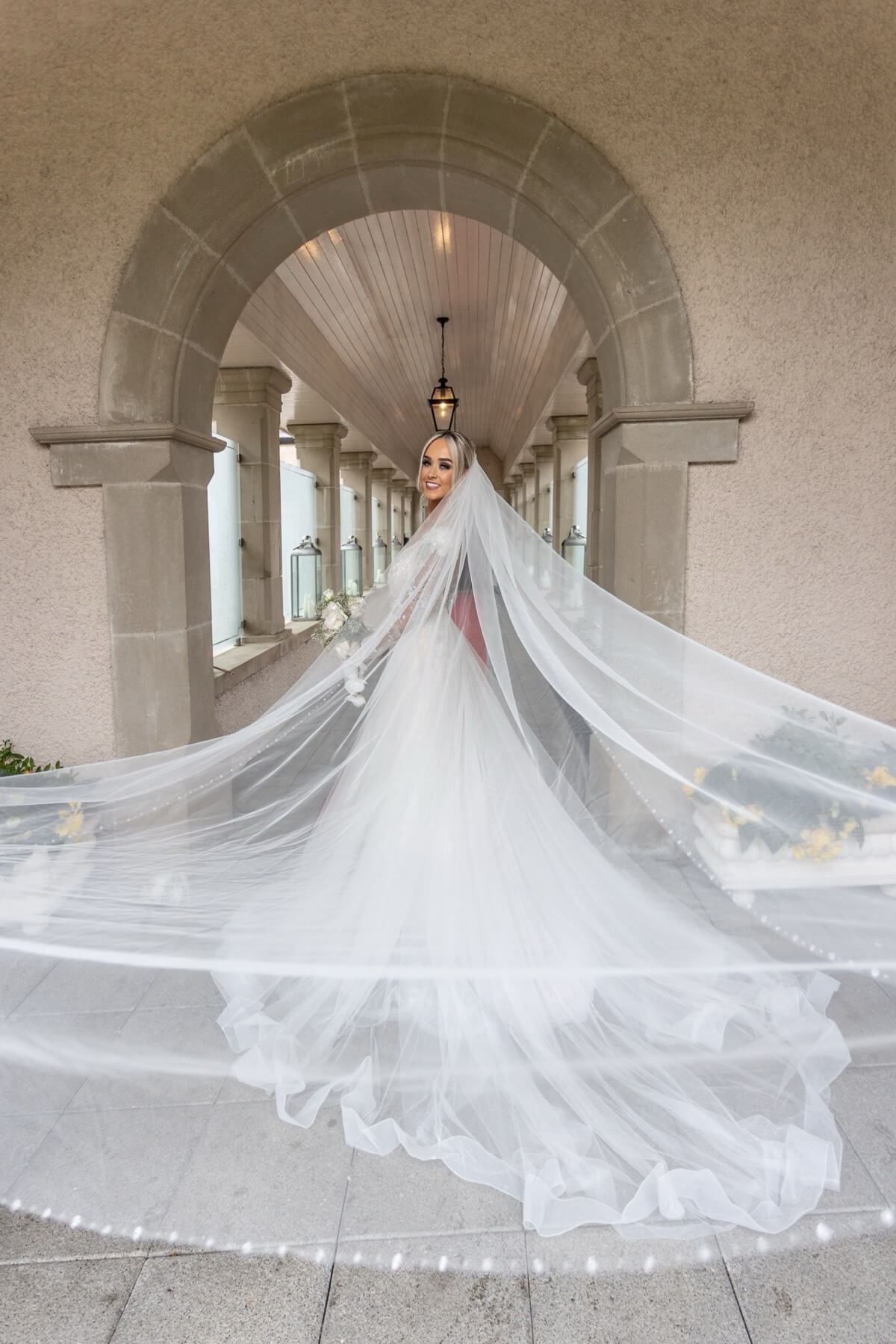 Bride in covered archway Lough Erne Resort