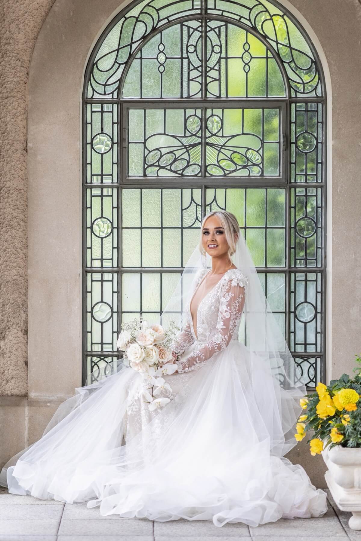 Bride at arched stained glass window Lough Erne