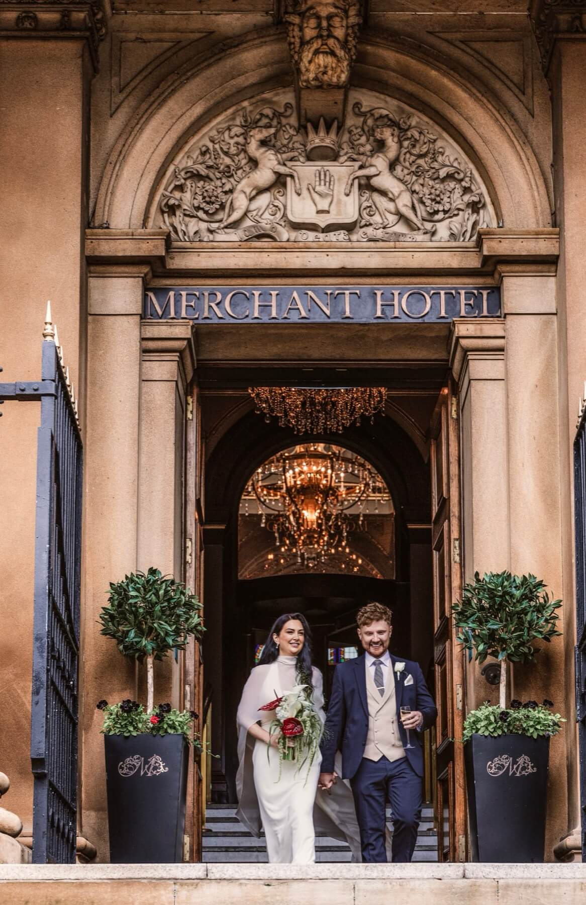 Merchant Hotel Belfast wedding couple ornate stone entrance arch Northern Ireland wedding photography