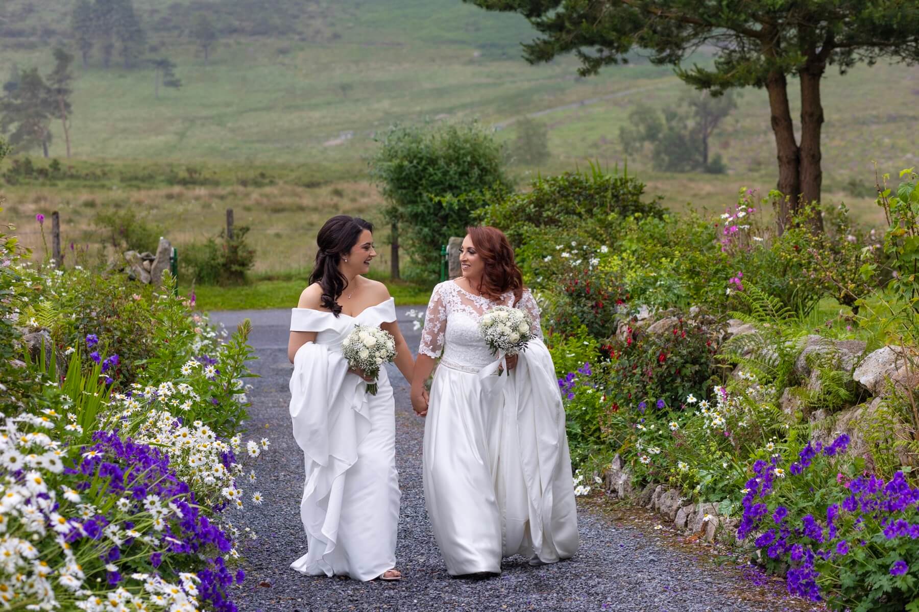 Wedding couple walking wildflower path Rocky Mountain